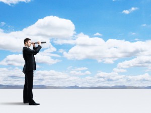 businessman looking through a telescope
